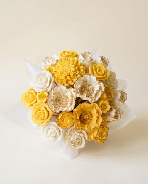 Bouquet of yellow and white 3S chocolate flowers on a light beige background