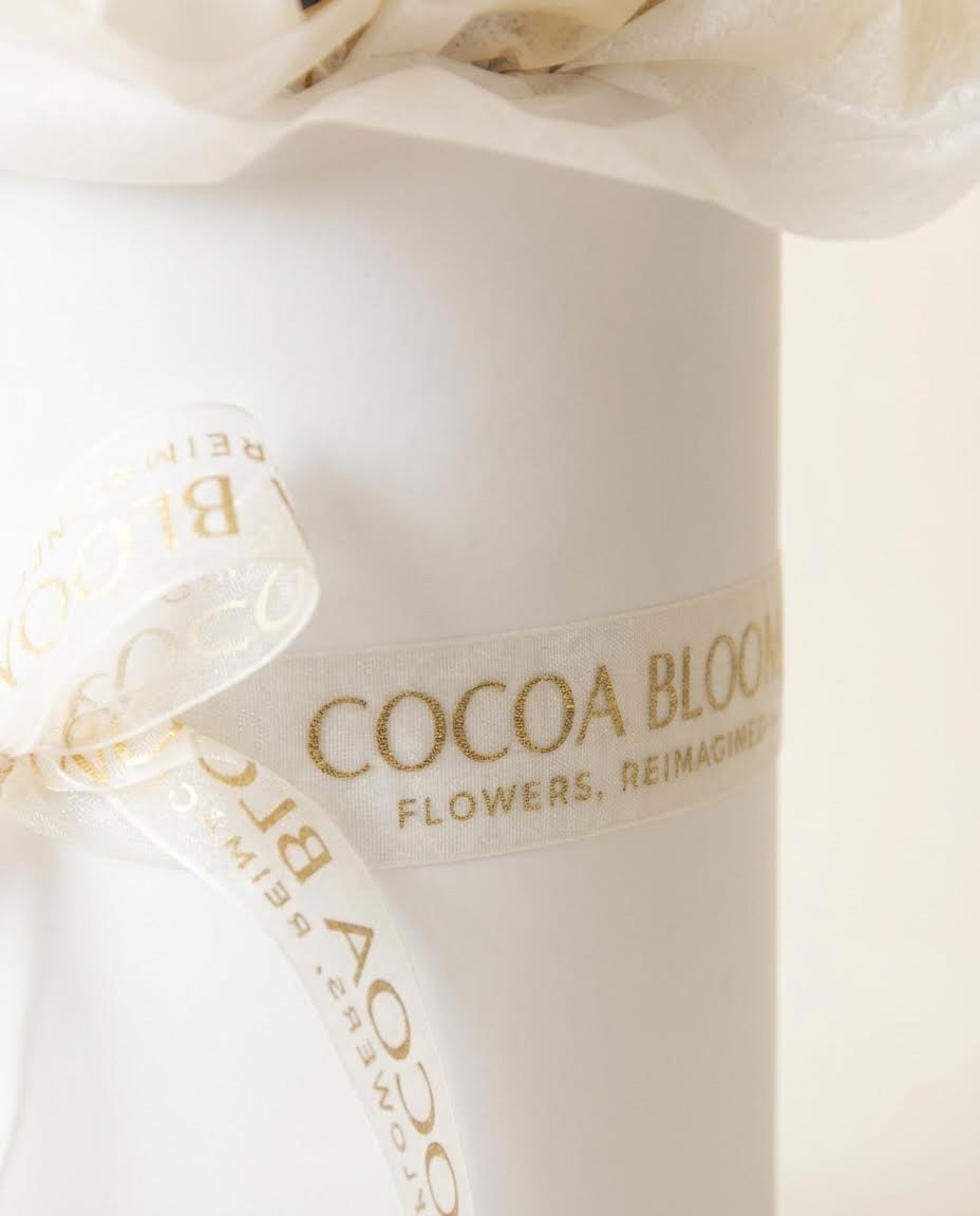 Cocoa Bloom flower box with organze ribbon on a white background
